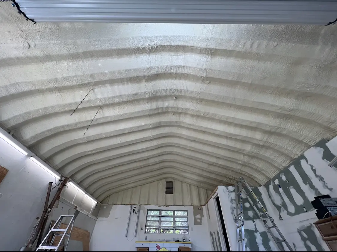 Spray polyurethane foam applied to the underside of a metal roof deck in Brownsville